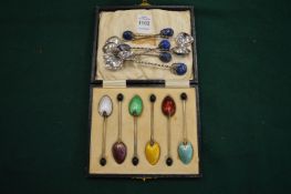 Cased set of six enamel and silver coffee bean spoons and other coffee spoons.