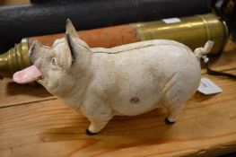 A cast iron pig with articulated tongue.