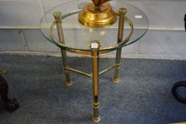A pair of brass framed circular glass top lamp tables.