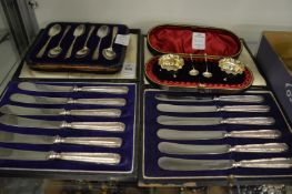 Two cased sets of silver handled butter knives, set of six silver teaspoons and a cased pair of