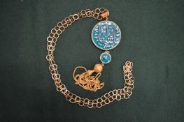 An Egyptian pendant and chain.