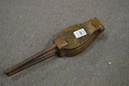 An unusual cast bronze spoon former.