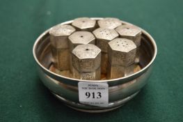 Silver wine coaster and a group of Eastern white metal salt and peppers.