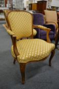 A French style beech framed open armchair.