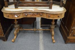 A Victorian walnut kidney shaped desk.