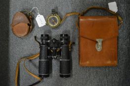 Leather cased military compass and a pair of leather cased binoculars.