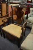 A George III elm open armchair.