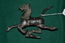 Cast metal model of a prancing horse.