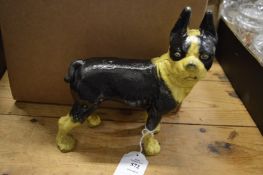 A cast iron dog door stop.