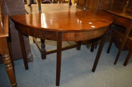 A mahogany demi-lune table.
