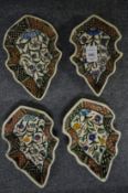 A set of four Islamic leaf shaped dishes.