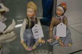 A pair of Copenhagen figures depicting a boy and a girl each in National costume.