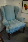 A good George III design wing armchair with classical style upholstery on carved cabriole legs