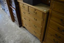 An ash chest of drawers.
