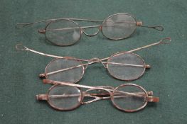 Three pairs of old spectacles.
