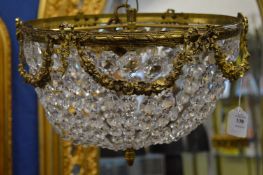 An ornate brass and cut glass chandelier.
