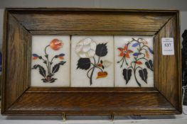 A set of three pietra dura plaques in an oak frame.