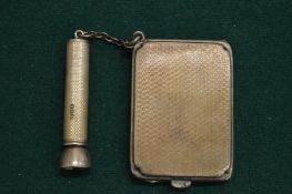 A silver match case and cigar pricker.