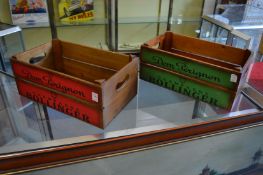 A pair of wooden storage boxes decorated with champagne names.