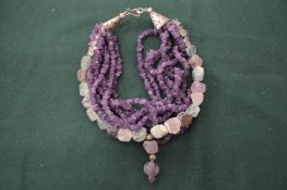 An amethyst and jade necklace.