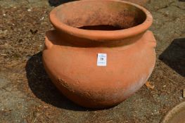 A twin handled terracotta plant pot.