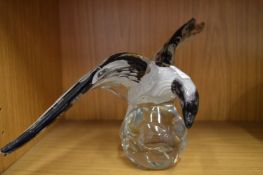 An Art glass model of a bird (chip to wing).