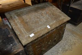 An embossed brass log box.