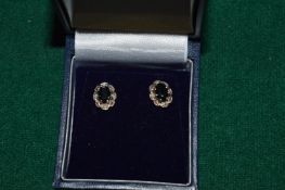 A pair of 9ct gold diamond and sapphire ear studs.