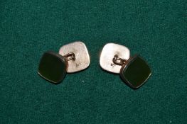 A pair of 9ct gold and green stone cufflinks.