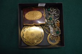 Bijouterie and two compacts.