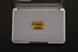 An emerald cut citrine, boxed with certificate.
