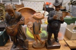 A pair of carved and painted wood figures of musicians and other items.