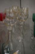 Seven Continental hock or wine glasses with twisted stems.