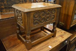 A carved oak storage box.