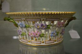 A Royal Copenhagen Flora Danica porcelain twin handled basket decorated with flowers and fruit.