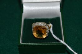 A good citrine and diamond ring stamped 18ct and platinum.