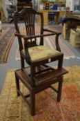 A George III mahogany high chair complete with original foot rest and base.