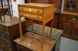 A satinwood occasional table with two rosewood banded drawers on tapering square legs.