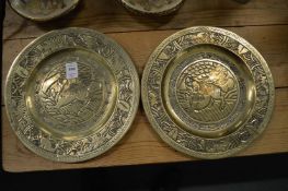 A pair of Chinese brass dishes engraved with dogs of foe.