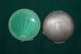 Silver and enamel compact and another silver compact.