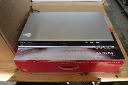 A karaoke player, a wall clock and a print.