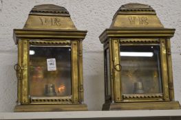 A pair of brass wall lights modelled as Victorian lanterns.