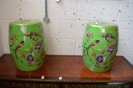 A pair of Chinese style green painted barrel seats decorated with birds.