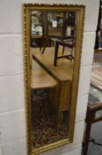 A gilt framed wall mirror.