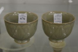 A pair of Chinese celadon glazed small bowls.