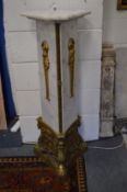 A decorative marble and ormolu triangular form pedestal column.