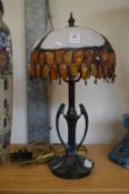 A Tiffany style bronze table lamp with stained glass shade.