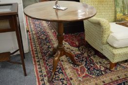 A George III oak circular tilt-top tripod table.