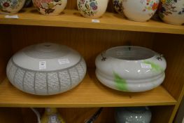 Two decorative glass ceiling shades.