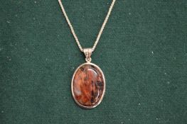 Decorative silver pendant and chain.